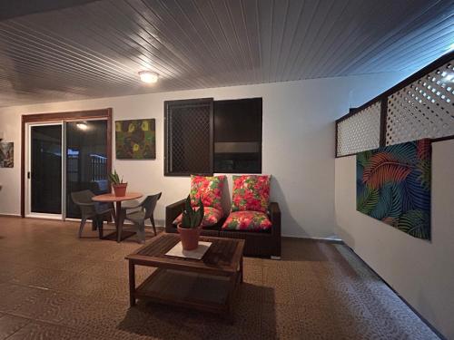 a living room with a couch and a table at Chez Tamatuamai in Avatoru