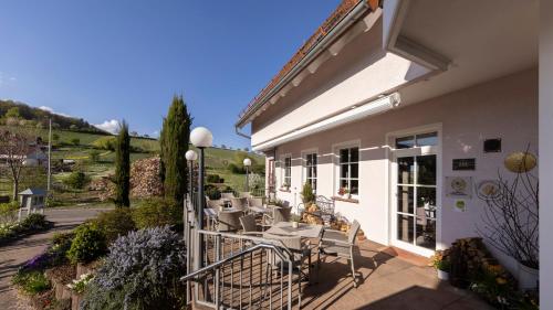 a patio with chairs and tables on a building at Castell Hotel & Restaurant in Leinsweiler