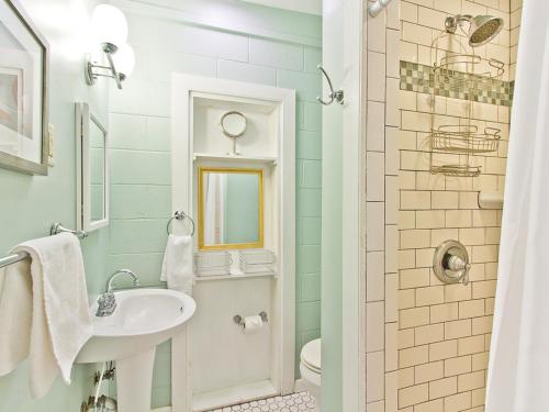 a bathroom with a sink and a toilet at Salty Pause in Tybee Island