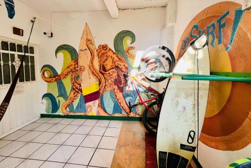 a room with a surfboard leaned against a wall at Palmar la Punta 4 Starlink 2min walk to the beach in Brisas de Zicatela