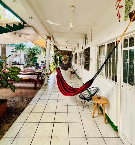 a hammock on the porch of a house at Palmar la Punta 4 Starlink 2min walk to the beach in Brisas de Zicatela