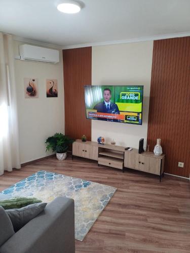 a living room with a flat screen tv on a wall at Refugio de Moncorvo in Torre de Moncorvo