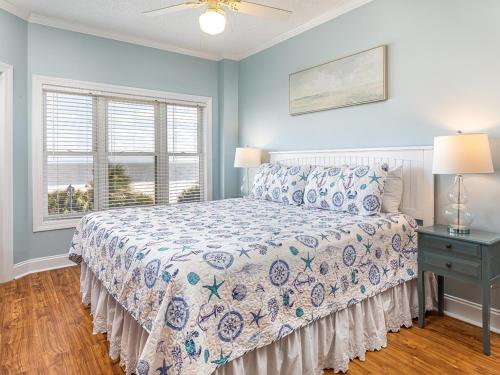 a bedroom with a bed and a window at Sandpiper 203 in Tybee Island