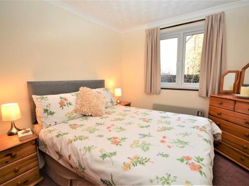 a bedroom with a bed and a window at 4 bed in Ousby 80541 in Ousby