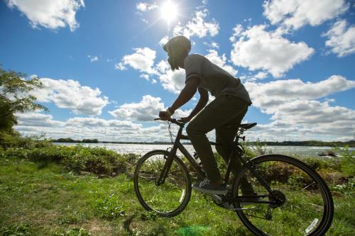 a man riding a bike in the grass at Holiday Inn Niagara Falls State Park Entry by IHG in Niagara Falls