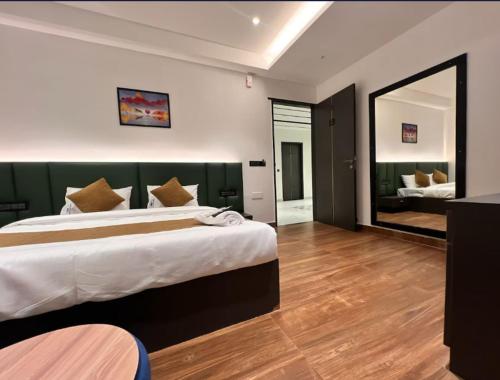 a bedroom with a large bed and a mirror at kingdom in Itʼkhvisi