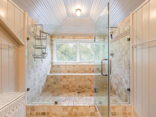a bathroom with a shower with a glass shower stall at Ocean Oasis in Tybee Island