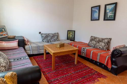 a living room with two couches and a coffee table at Hola Surf Morocco in Agadir