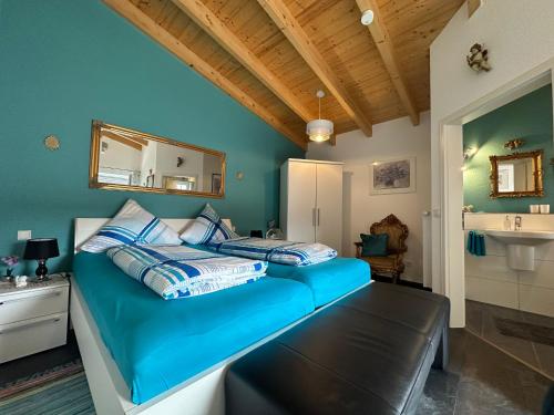 a bedroom with a blue bed and a sink at Gästehaus Jupp und Kerstin Korz GbR in Hackenheim