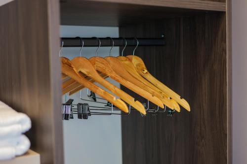 a bunch of wooden utensils hanging on a rack at Joelle Premium Hotel in Sarandë