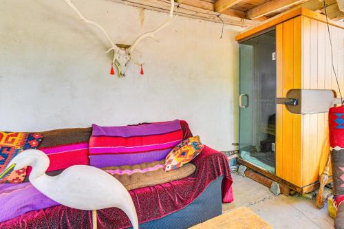 a living room with a couch and a white bird at Adobe Studio 2 Blocks to Dtwn Santa Fe Plaza! in Santa Fe