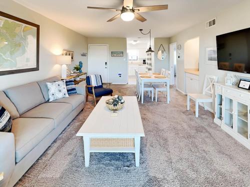 a living room with a couch and a table at Lighthouse Point 15C in Tybee Island