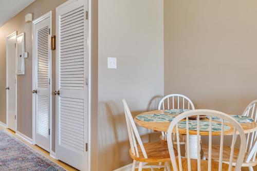 a dining room with a table and chairs at Emerald Isle Condo Near Beach with Screened Porch! in Emerald Isle