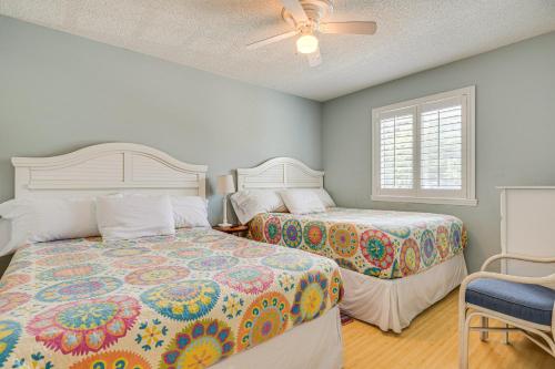 a bedroom with two beds and a ceiling fan at Emerald Isle Condo Near Beach with Screened Porch! in Emerald Isle