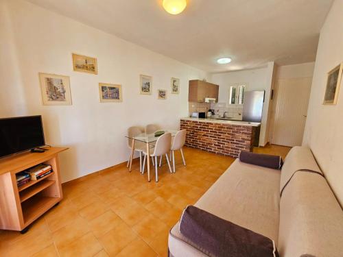 a living room with a couch and a table at Corfu Glyfada Beach Apartment 49 in Corfu