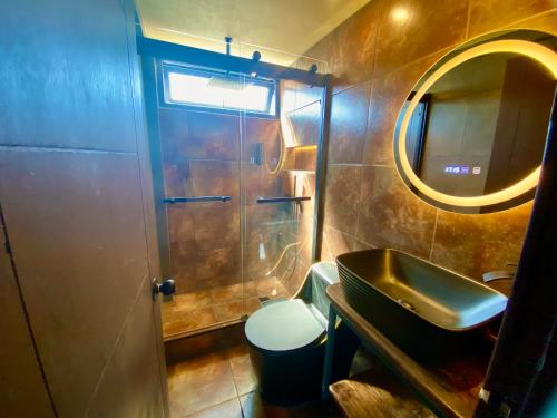 a small bathroom with a sink and a mirror at Cabañas Leufü Lodge con Tinaja in Valdivia