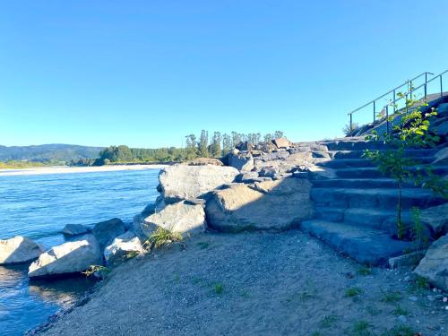 a set of stairs next to a body of water at Cabañas Leufü Lodge con Tinaja in Valdivia