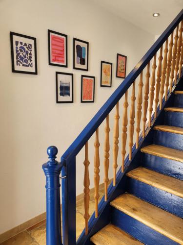 a set of stairs with framed pictures on the wall at Grossvaters Haus - Oba's Heisle in Lauingen