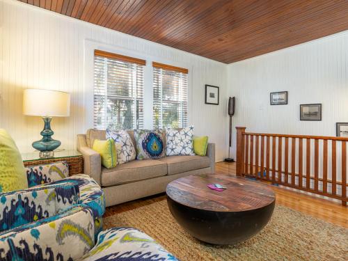a living room with a couch and a coffee table at Guiding Light Cottage in Tybee Island
