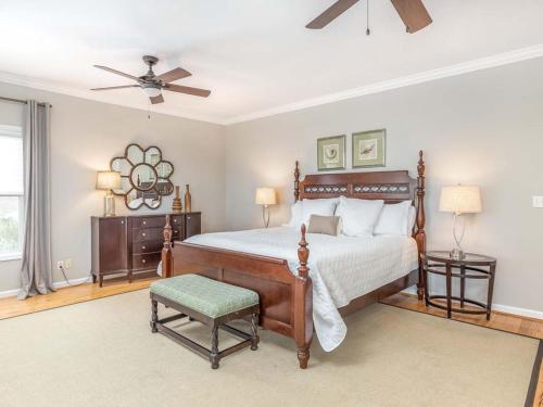 a bedroom with a bed and a ceiling fan at Driftaway in Tybee Island