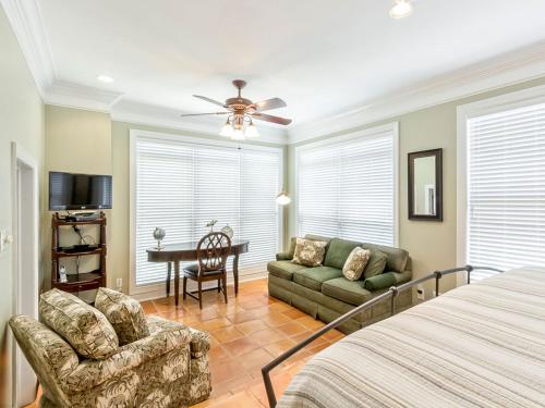a bedroom with a bed and a couch and a table at Driftaway in Tybee Island