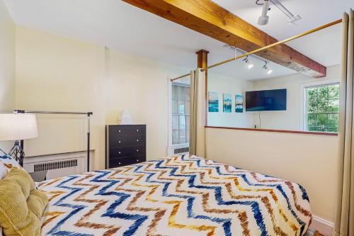 a bedroom with a king sized bed and a window at Stowe Mountain Road Escape in Stowe