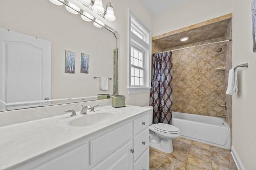 a white bathroom with a sink and a toilet at My Turn at Surf City in Surf City