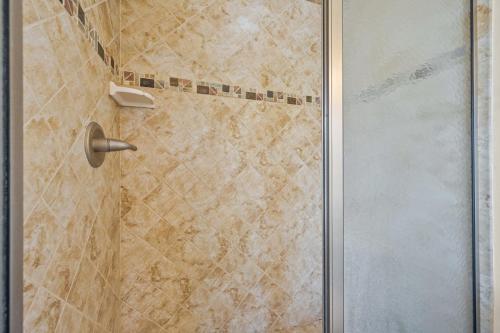a shower with a glass door in a bathroom at My Turn at Surf City in Surf City