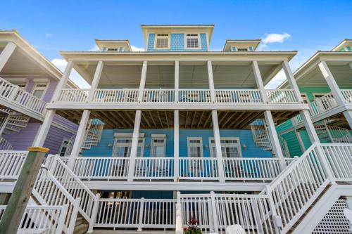 a large house with white balconies on a beach at My Turn at Surf City in Surf City