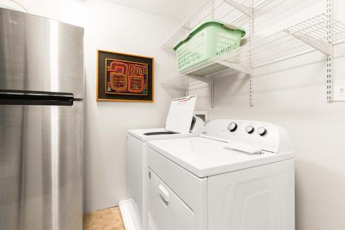 a white laundry room with a washer and dryer at Colonels Retreat in Tybee Island