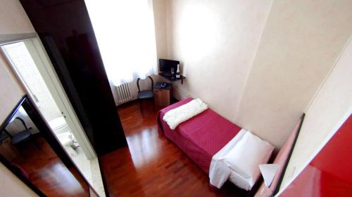 a living room with a red couch in a room at Hotel Nettuno in Porto San Giorgio