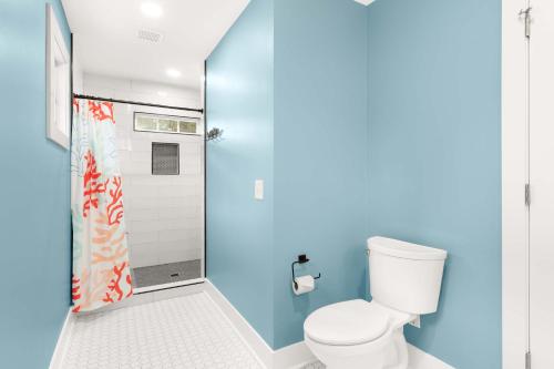a bathroom with a toilet and a shower at Castaway Cottage in Tybee Island