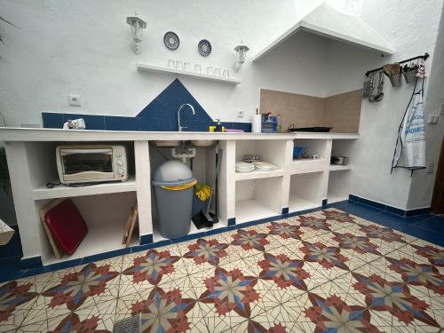 a kitchen with a sink and a counter with a microwave at casa los almendros in Confrides
