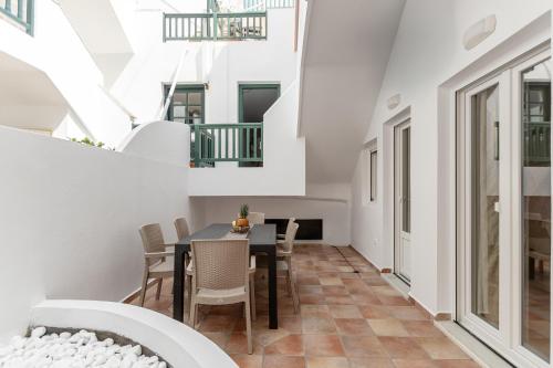 a dining room with a table and chairs at Golden Bay in Agios Prokopios