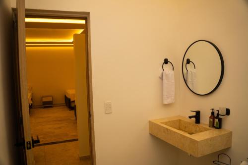 a bathroom with a sink and a mirror on the wall at Palmarito Beach Hotel in Tierra Bomba