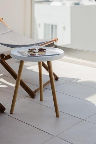 a table and a chair in a room at Fl9 Thelodge-sea View W Huge Terrace By Homely in Mellieħa