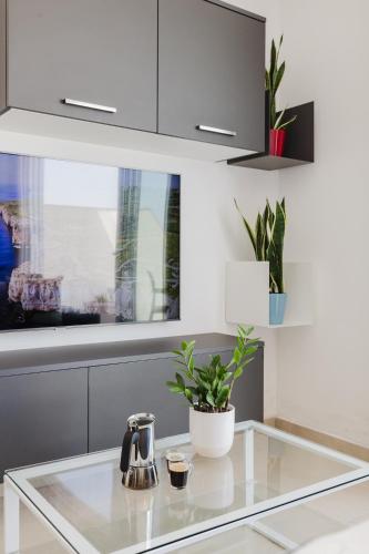 a kitchen counter with a tea kettle and plants on it at Fl9 Thelodge-sea View W Huge Terrace By Homely in Mellieħa