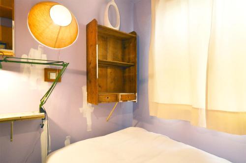 a bedroom with a medicine cabinet and a bed at Apartment Hotel Shinjuku in Tokyo