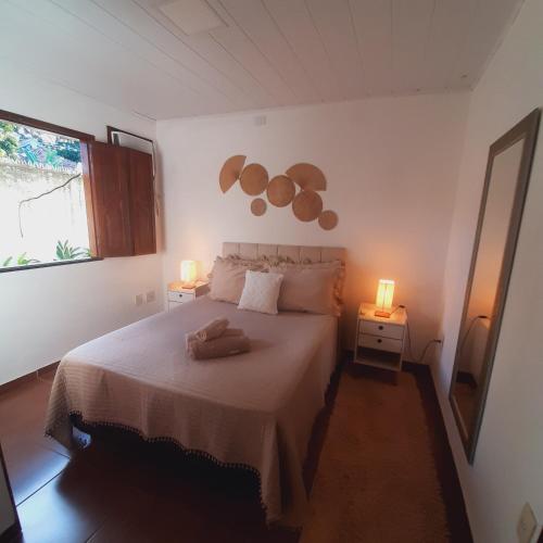 a bedroom with a bed with two lights on it at Residência Thomas in Itacaré