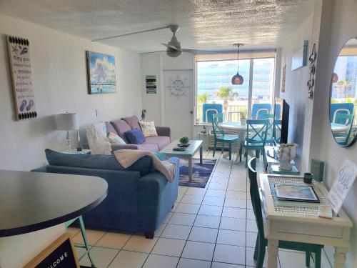 a living room with a couch and a table at Beachside Bliss Ocean-View Condo with Pool and Private Beach Access Perfect for Families and Couples in Daytona Beach