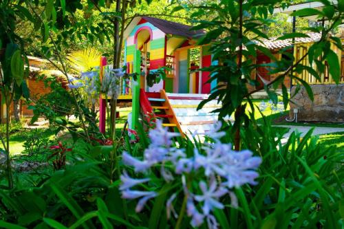 a colorful house with flowers in front of it at Hotel Villas del Valle in Valle de Ángeles