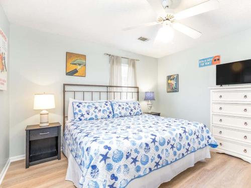 a bedroom with a bed and a ceiling fan at Beach Song in Tybee Island