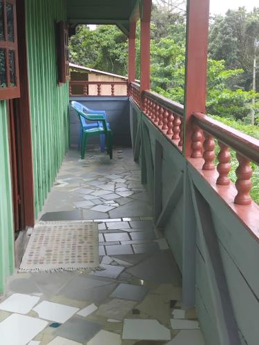 a balcony of a house with a blue chair at Casas Salomão in Santo António