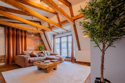 a living room with a couch and a table at L&C-Elbresidenzen & Suites am Elberadweg in Magdeburg
