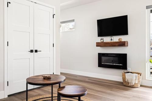 a living room with two tables and a fireplace at Golden Sanctuary Luxe Apt 1 Block From Main St in Golden