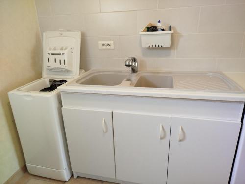 a kitchen with a sink and a dishwasher at Gîte la plairie in Dragey