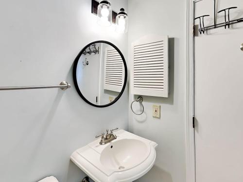 a bathroom with a mirror and a sink at Beach Racquet A301 in Tybee Island