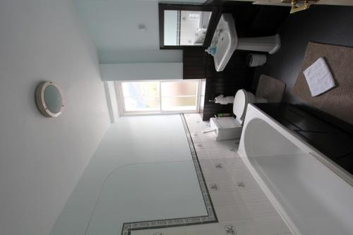 a small bathroom with a toilet and a window at The Eagles Bunkhouse in Betws-y-coed