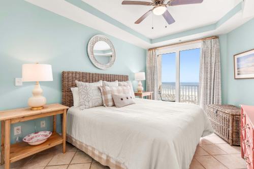 a bedroom with a bed with a view of the ocean at Beach House 432 in Tybee Island
