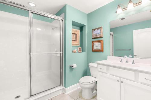 a bathroom with a shower and a toilet and a sink at Beach House 432 in Tybee Island